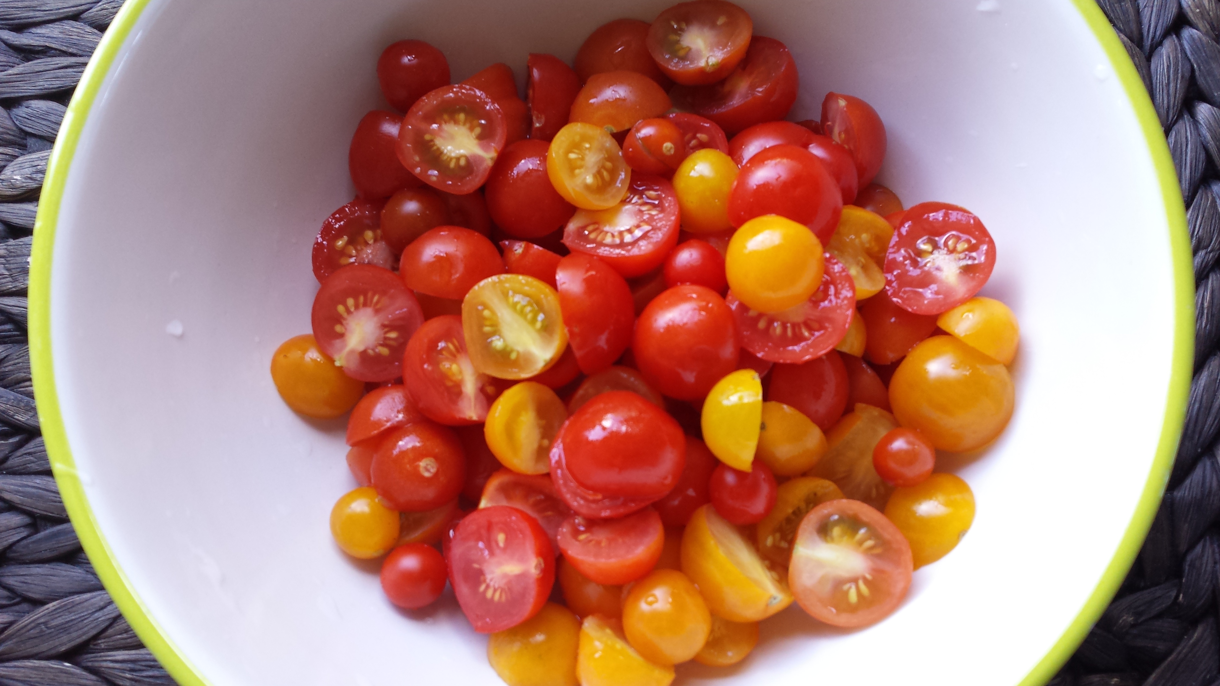Red yellow cherry tomatoes cut in half