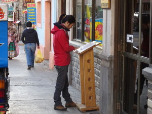 Looking serious to see the menu by a restaurant